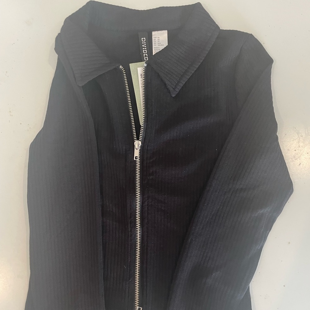 black sweater with zipper on both ends.